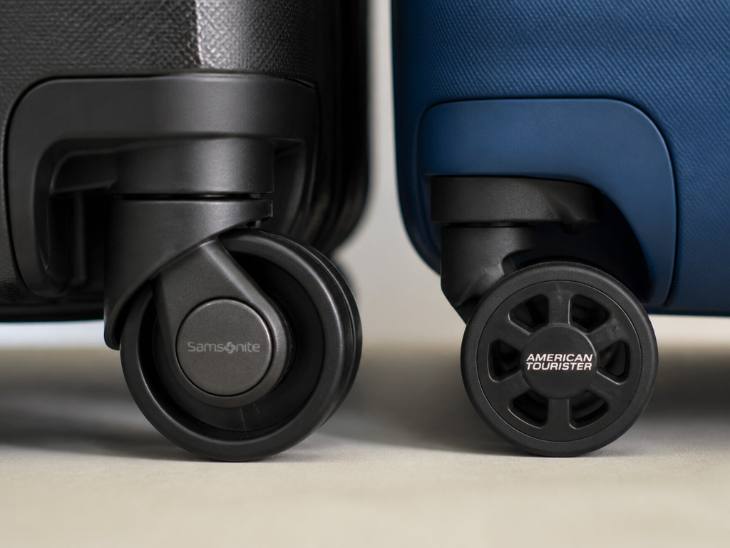 Comparison of premium Samsonite luggage wheel versus basic American Tourister wheel.