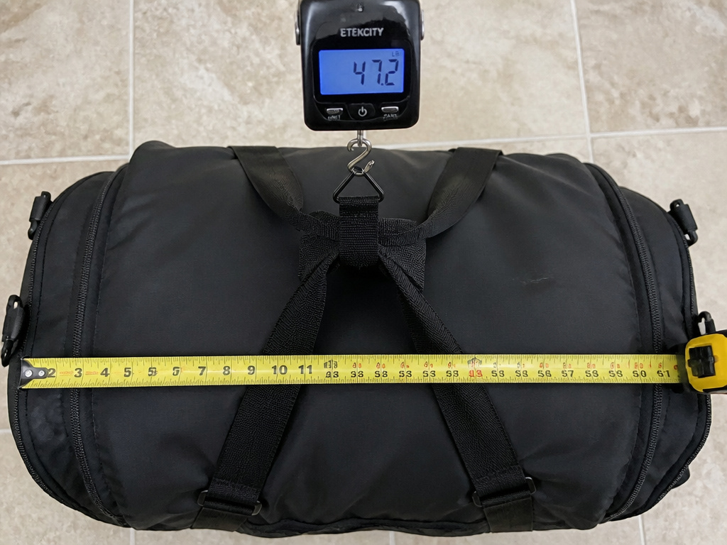 Measuring and weighing a stuffed duffel bag to meet airline checked baggage limits.